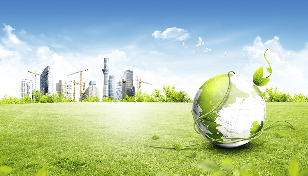 A grassy field with a vine-wrapped globe in the foreground symbolizes eco-friendliness. In the background, a city skyline with cranes under a clear blue sky.